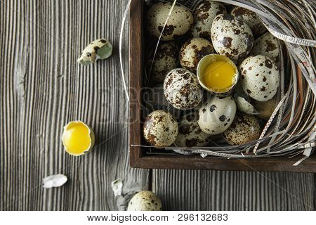 Quail Eggs. Flat Lay Composition With Small Quail Eggs On The Natural Wooden Background. One Broken