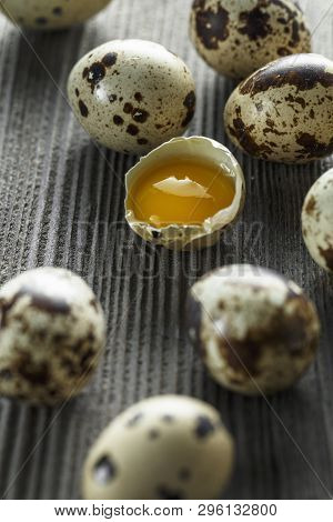 Quail Eggs. Flat Lay Composition With Small Quail Eggs On The Natural Wooden Background. One Broken