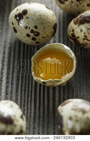 Quail Eggs. Flat Lay Composition With Small Quail Eggs On The Natural Wooden Background. One Broken