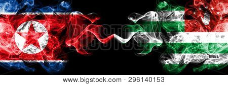 North Korea Vs Abkhazia, Abkhazian Smoky Mystic Flags Placed Side By Side. Thick Colored Silky Smoke
