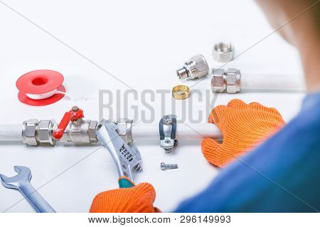 Plumber With Wrench Repair Pipeline. Service Pipe, Valve. Copy Space.