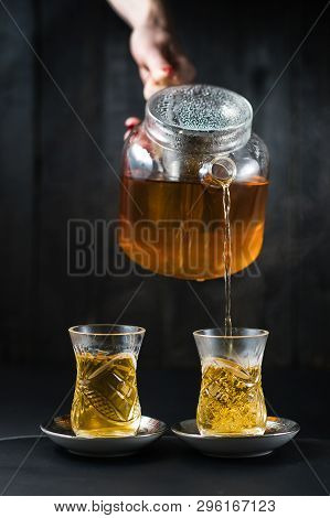 The Girl Pours Tea In An Armud.