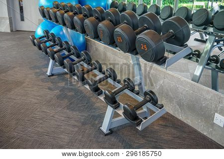 Dumbells Set Left On The Racks In The Gym. Healthy Or Sport Concept.