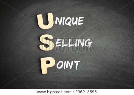 Wooden Alphabets Building The Word Usp - Unique Selling Point Acronym On Blackboard
