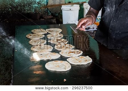 Indian Chapatti On Fire, Pushkar, India Close Up. Fried Tortillas On A Hot Baking Sheet. Street Food