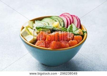 Traditional Hawaiian Poke Salad With Salmon, Avocado Rice And Vegetables In A Bowl.
