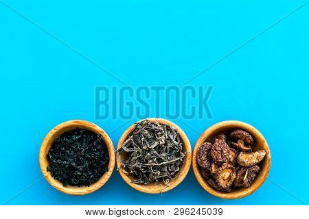 Chinese And Jupanese Food Cooking With Mushrooms, Spices, Weeds In Bowl On Blue Background Top View 