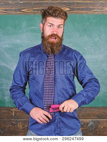 School Accident Prevention. Teacher Bearded Man With Pink Stapler Chalkboard Background. School Stat