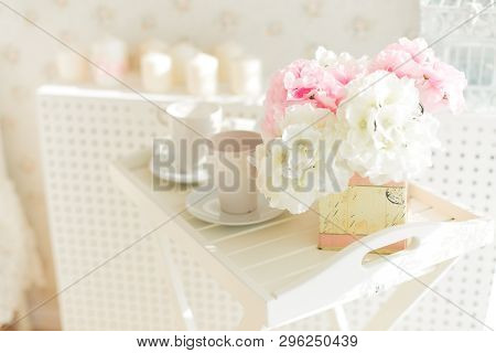 In A Bright Room On A White Wooden Tray There Are Two Mugs On The Saucers And A Yellow Box With Pink