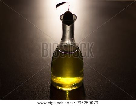 Oil Bottle With Olive With Black Background