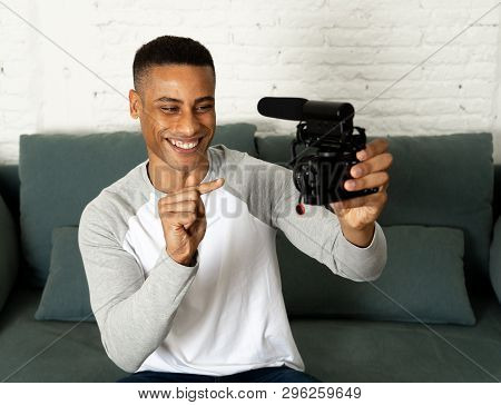 Young Happy Blogger Recording Video On Camera For Internet Blog