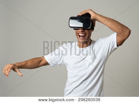 Portrait Of Cheerful And Shocked Young Man Wearing Virtual Reality Headset Exploring 3D World