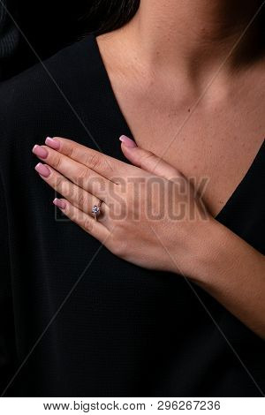 Womens Silver Diamond Ring In The Shape Of A Square With A Fringe On Finger, On A Black Background.