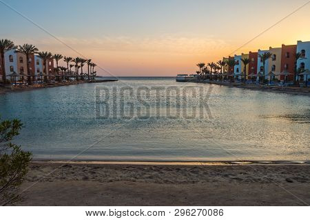 View Of A Lagoon Of The Red Sea At Sunrise Between Two Rows Of Hotel Room In Hurghada