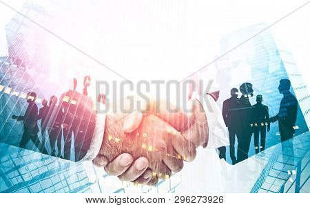 Two Unrecognizable Businessmen Shaking Hands Over Skyscraper Background. Business Team Silhouettes. 
