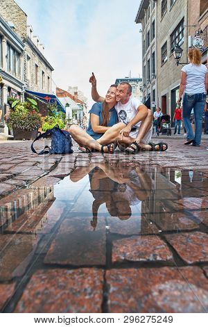 Montreal, Canada, September 3, 2018: Young Coupl Sitting On Street On Famous Saint-paul Street In Hi