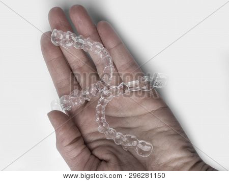 Taking Care Of Teeth. Close Up Of Clear Aligners In Hands, Orthodontic Device. Selective Focus And I