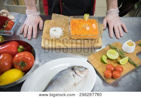 Restaurant Kitchen. Chef Servied Soup With Seafood Ingredients With A Rice