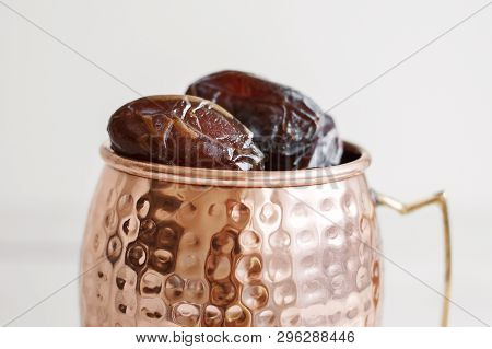 Sweet Dried Dates In A Brass Mug. Traditional Food During Holy Ramadan Month In Middle East