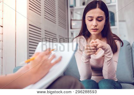 A Marriage Counselor Making Notes During Conversation With A Woman.