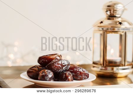 Serving Of Dried Dates And Gold Colored Lantern On Metal Tray, Festive Lights As Background. Ramadan