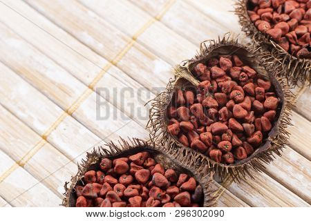 Annatto Seeds On Rustic Wood