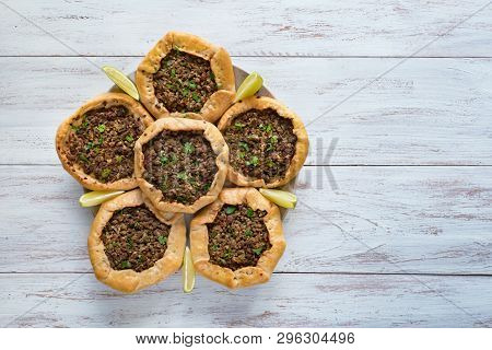 Arabic Meat Sfiha Over A Wooden Table. Top View Of Arabic Esfiha.