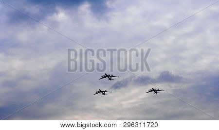 Silhouettes Flying Russian Tu-95 Bombers Against The Sky.