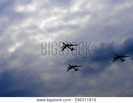 Silhouettes Flying Russian Tu-95 Bombers Against The Sky.