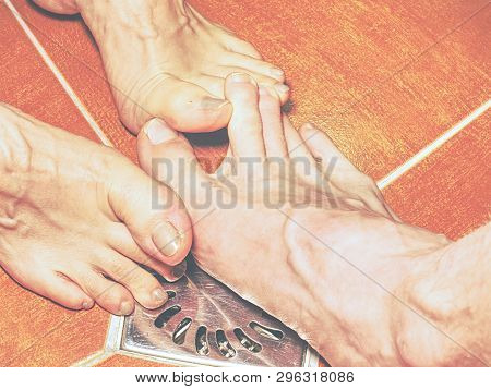 Feet Of Girlfriend  And Boyfriend Together In Tilled Shower Stall. Modern Design Of Bathroom.