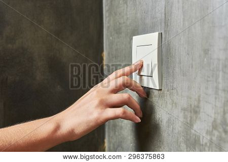 Female Hand, To Turn Off The Light, Switch, Front View.
