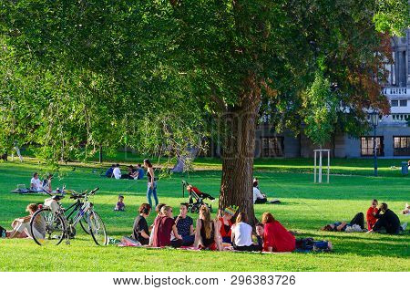 Vienna, Austria - September 17, 2018: Company Of Young People Is Resting In Popular Public Burggarte
