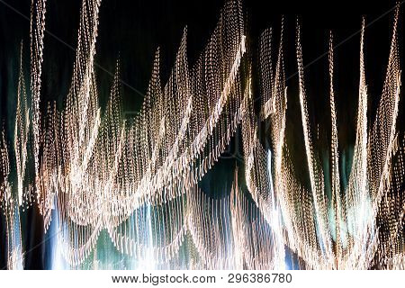 Abstract Of Multicolored Lights Stripes Moving Fast In Dark Background. Orange Violet And Bluel Back