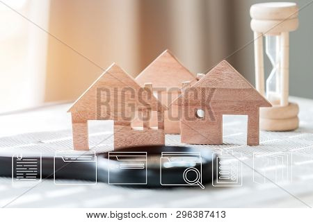 Real Estate Propery Concept : Digital Document File Marketing Icons On Wood House Model With Hourgla