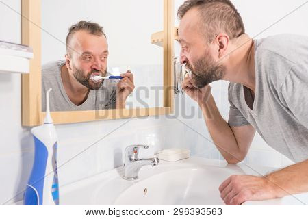 Funnny Guy Taking Care Of His Oral Hygiene, Brushing Teeth During Morning Bathroom Routine.