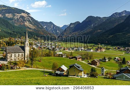 Awesome Alpine Highlands In Sunny Day. Wonderful Alpine Landscape. Churh In Gosau Village At Sunny D