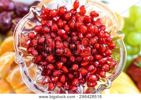 Red Pomegranate Seeds In A Bowl With Fresh Berries And Fruits