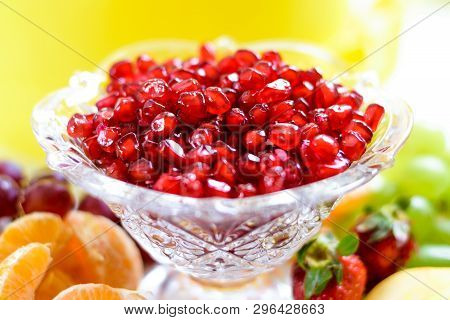 Red Pomegranate Seeds In A Bowl With Fresh Berries And Fruits