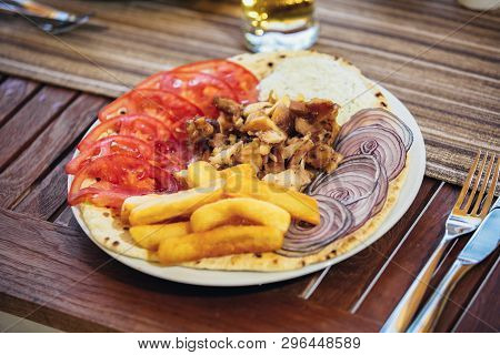 Greek Gyros With Tzaziki And Fries On Table