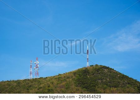 Telephone Attennas On The Mountain Against Blue Sky Background