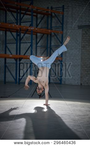 An Athletic Man On Capoeira Training. Staning In The Pose. Standing On One Hand