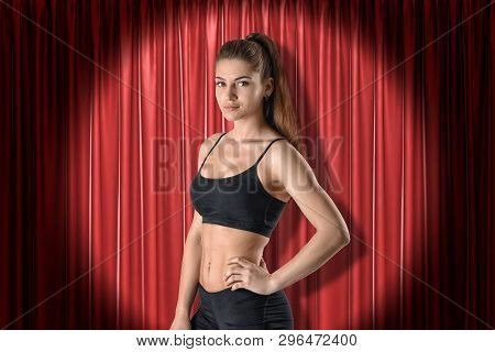 Close-up Of Young Woman In Black Sport Crop Top And Shorts Standing In Half-turn With One Hand On Hi