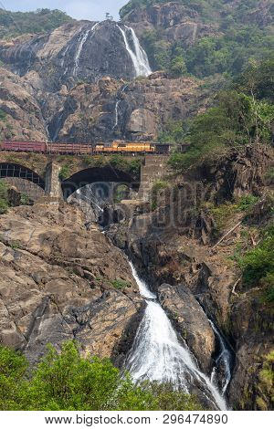 Train On The Railway Bridge On The Background Of The Dudhsagar Falls