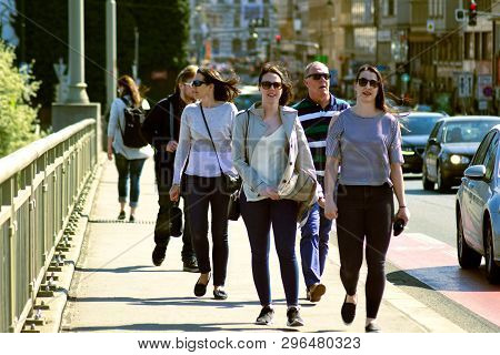 Praque, Czech Republic, April 18. 2019: Group Of People On The Street By The Road In The City