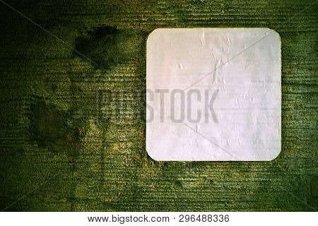 One Empty Swhite Leaf Of Paper Or Clean Sticker Closeup On An Old Concrete Wall For A Background Wit