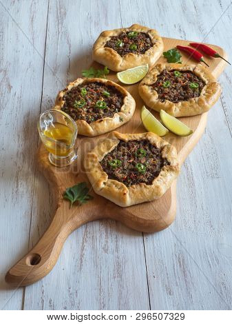 Open Meat Pies On A Wood Background. Top View