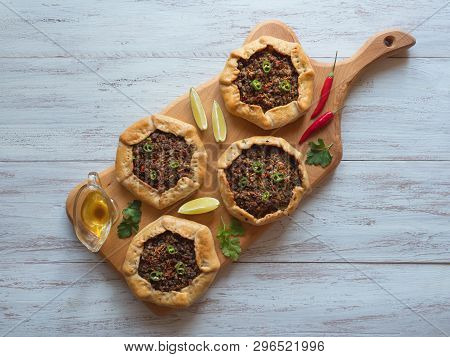 Open Meat Pies On A Wood Background. Top View