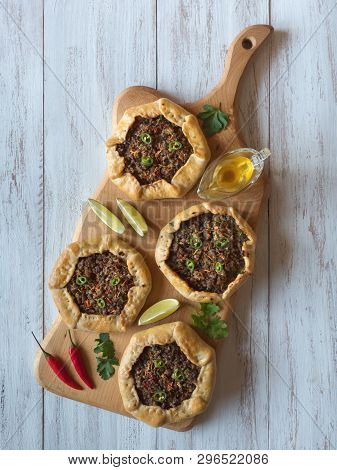 Open Meat Pies On A Wood Background. Top View