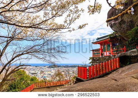 The Kamikura Shinto shrine at the top of a hill against a large rock boulder, Shingu, Japan