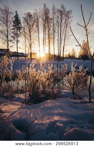 Cold Winter Morning With Sun Rising Between Trees On The Other Side Of The River, Forssa Finland